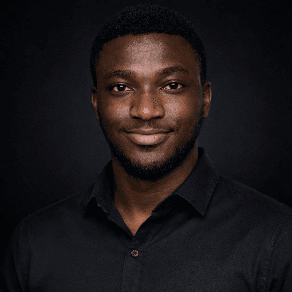 Samuel Oyenuga smiling, in a black shirt